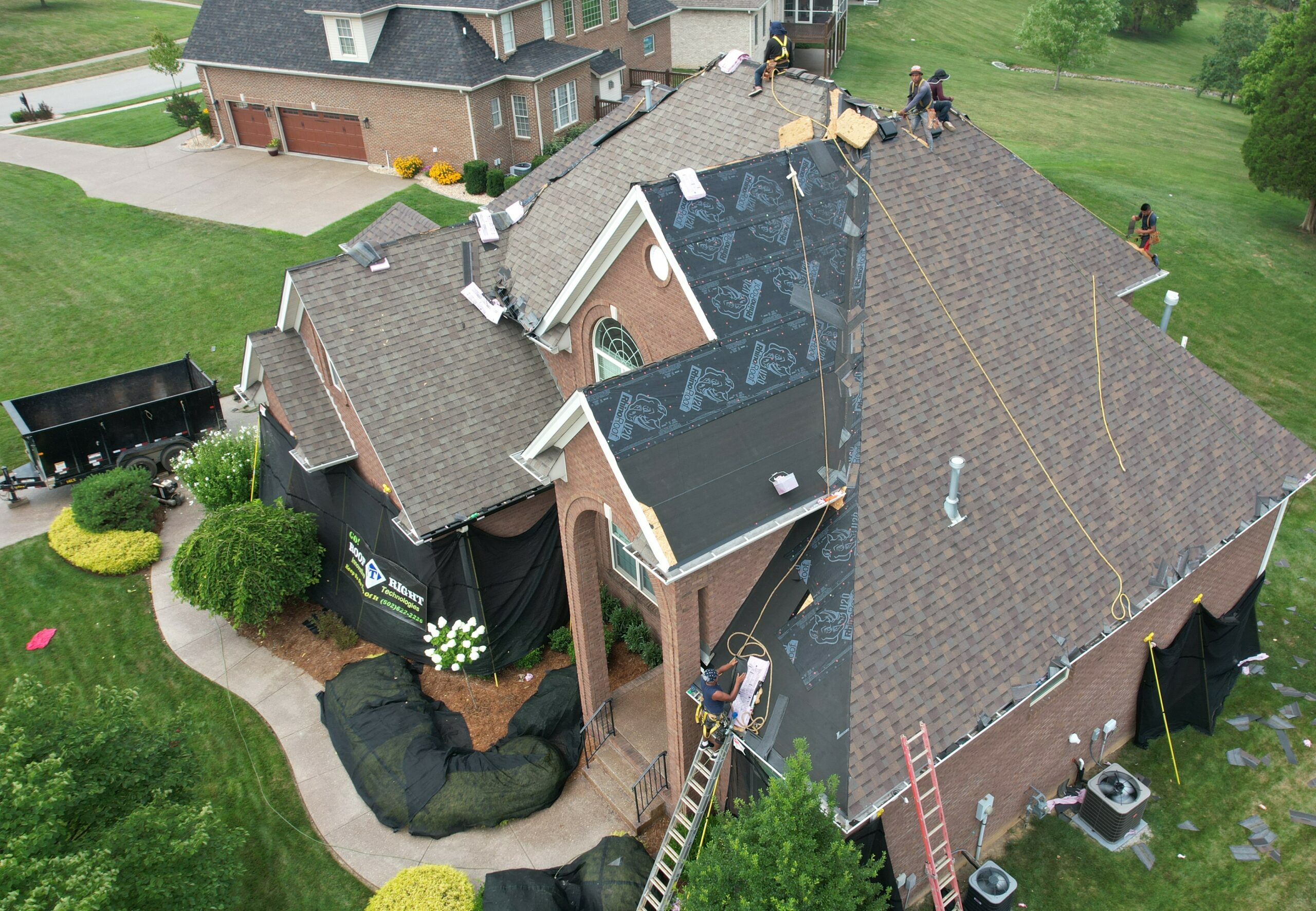 Doing it right requires strictly adhering to OSHA safety standards. These installers are safely tied to the roof with ropes and harnesses per OSHA standards for a roof with this slope.