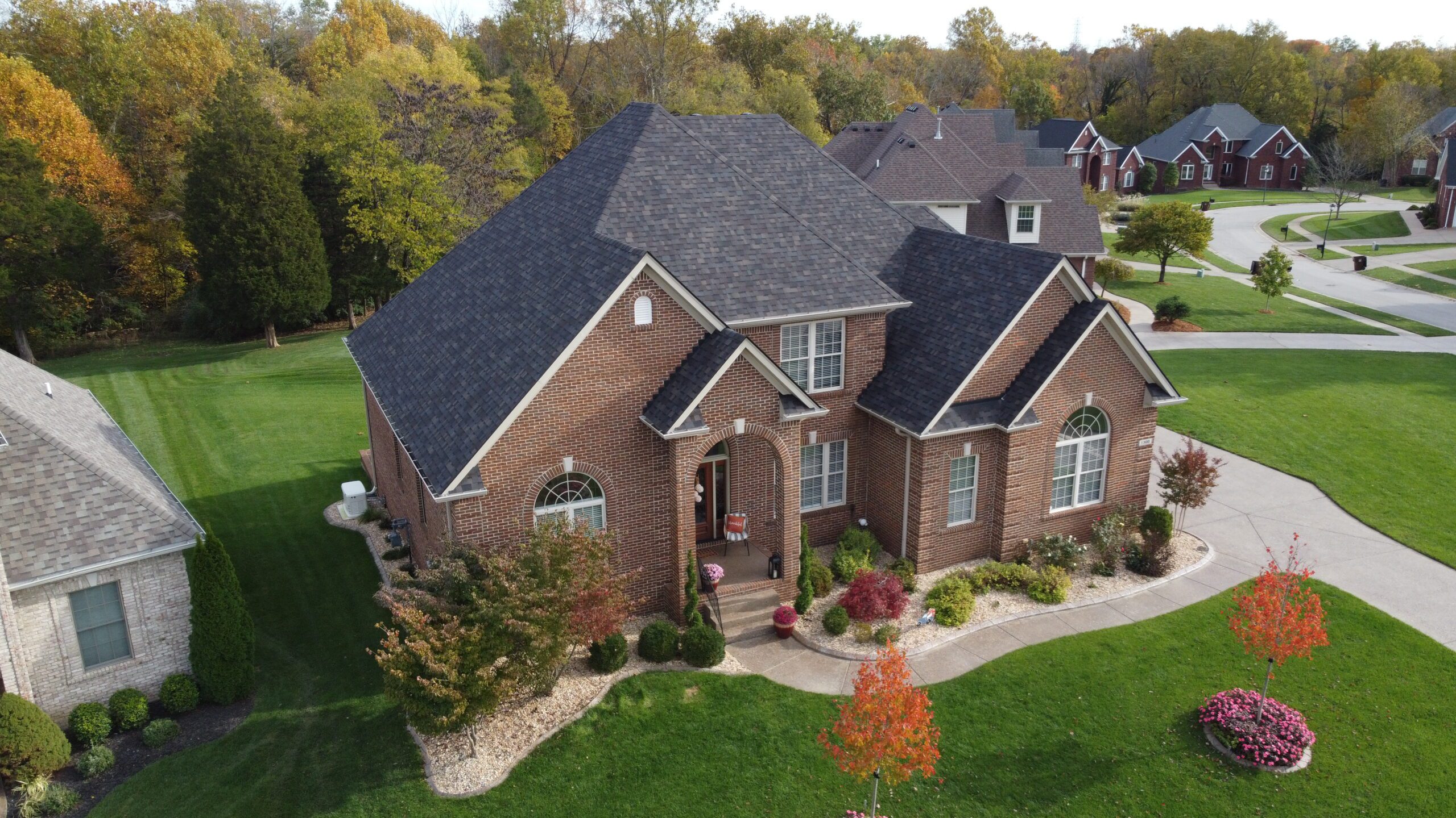 Aerial view of home with new roof and shingles