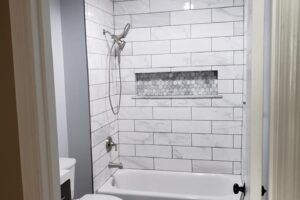 Remodeled bath with white tile