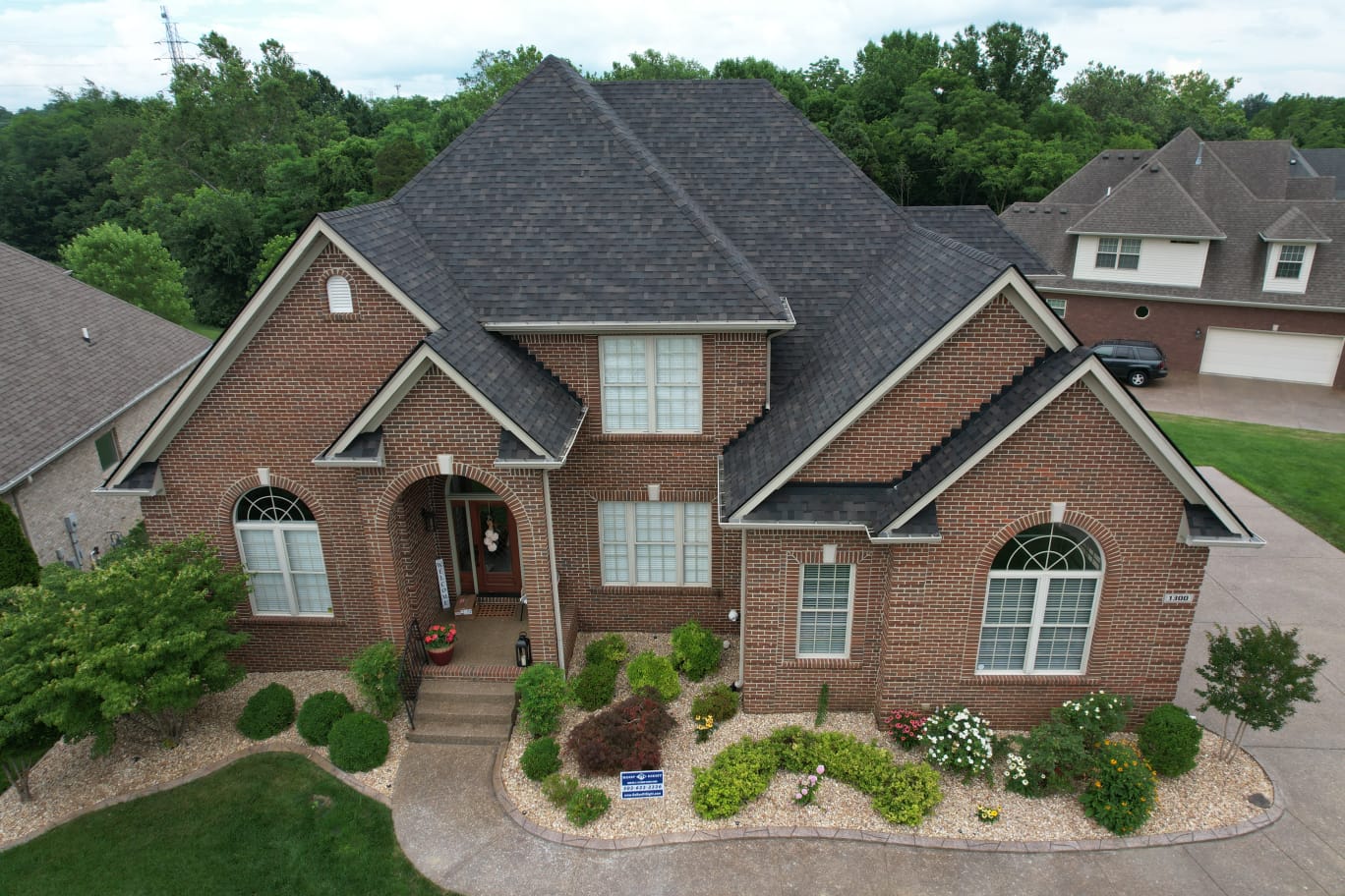 Aerial view of home with new roof and gutters