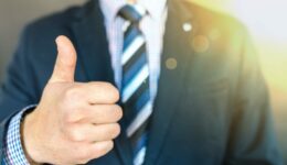 Man in business suit with thumbs up