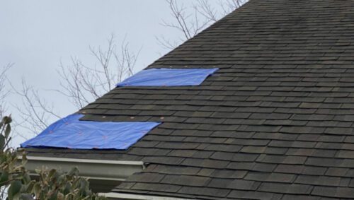 Temporary tarps preventing roof leaks